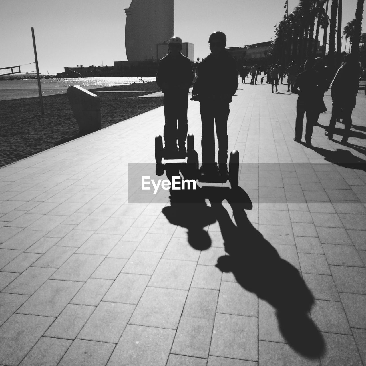 Two segway riders on sidewalk