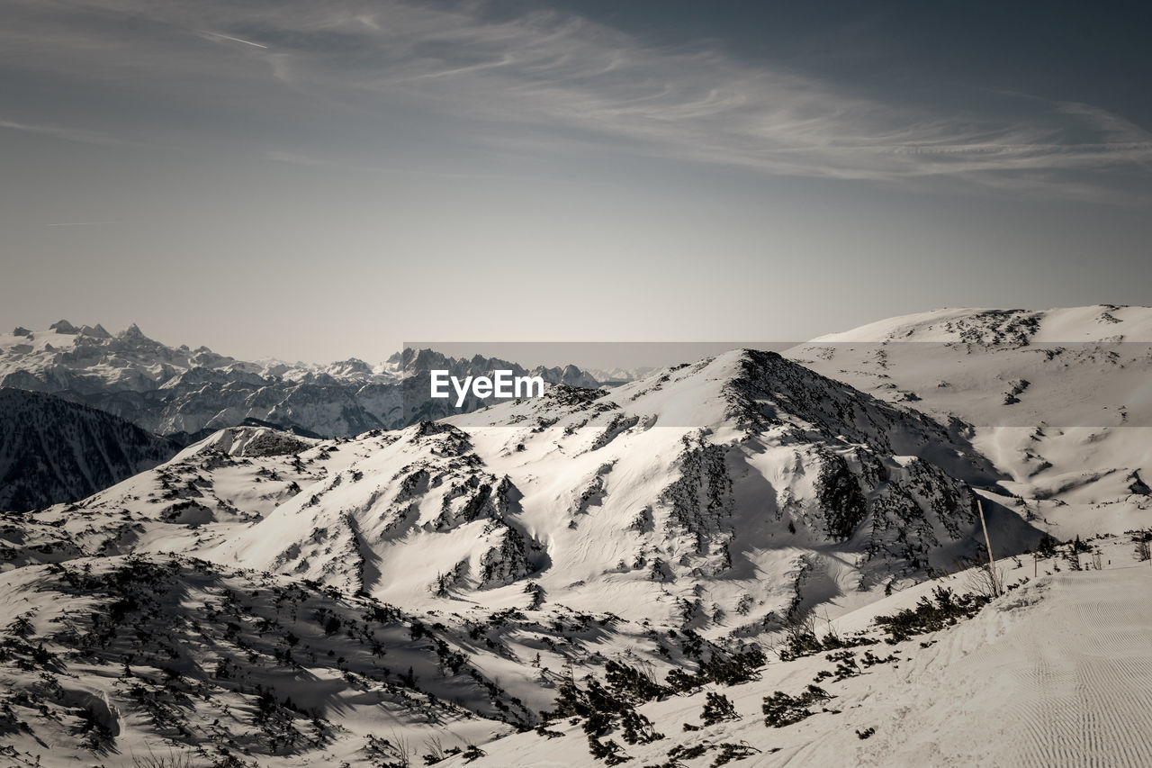 Scenic view of snow covered mountains against sky