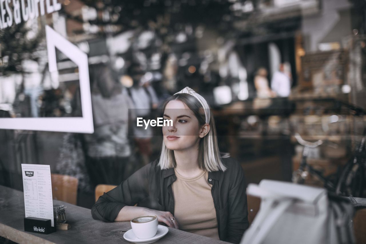 Young woman with coffee cup in cafe