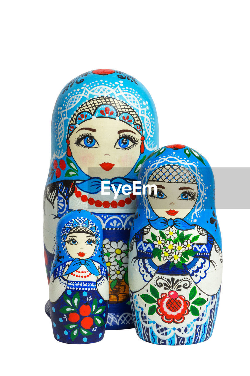 Close-up of matryoshka dolls against white background