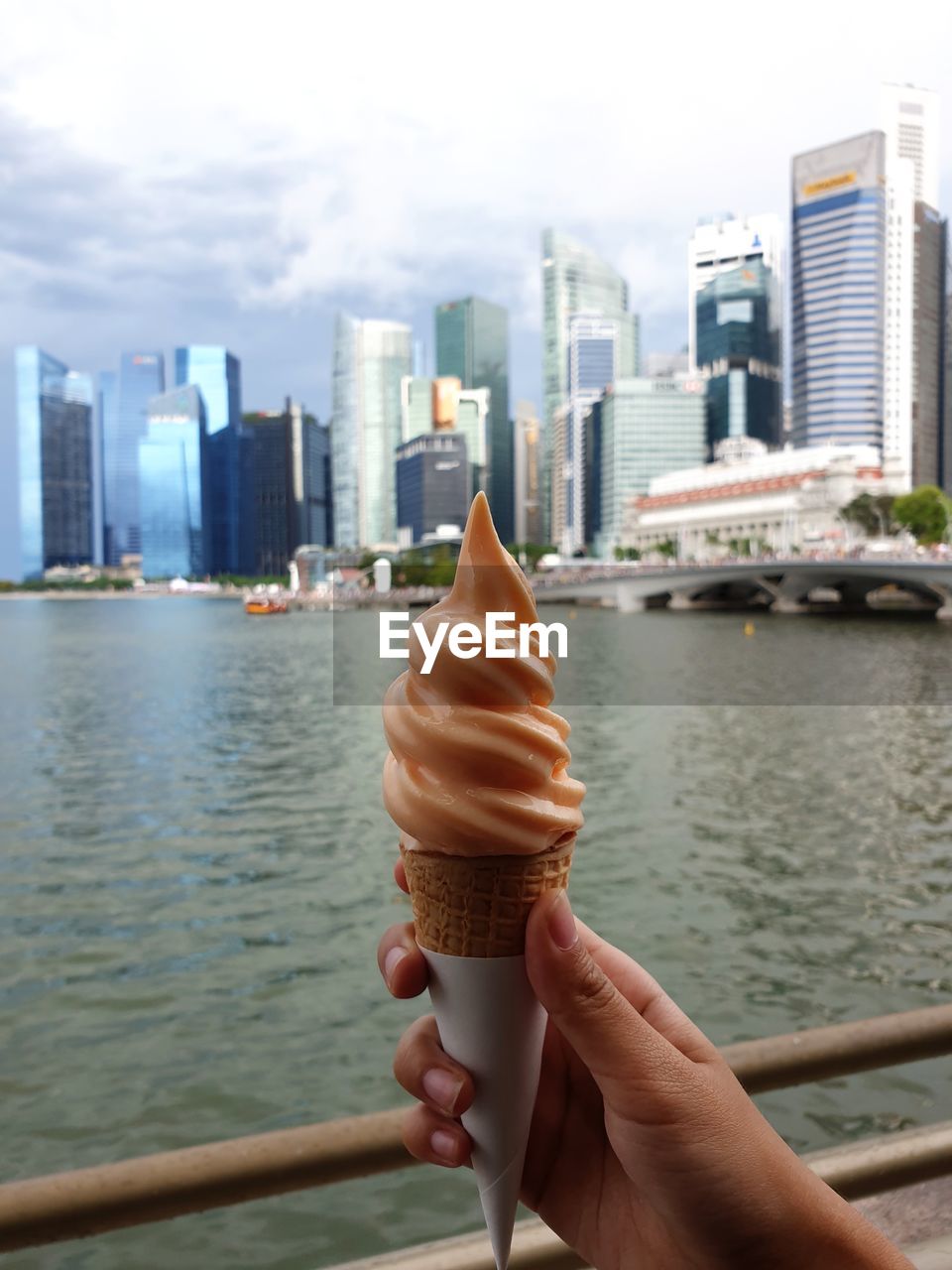 Person holding ice cream cone in city