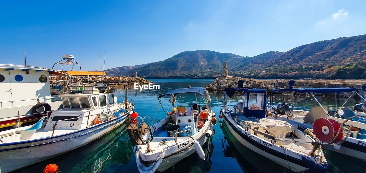 BOATS MOORED IN BAY