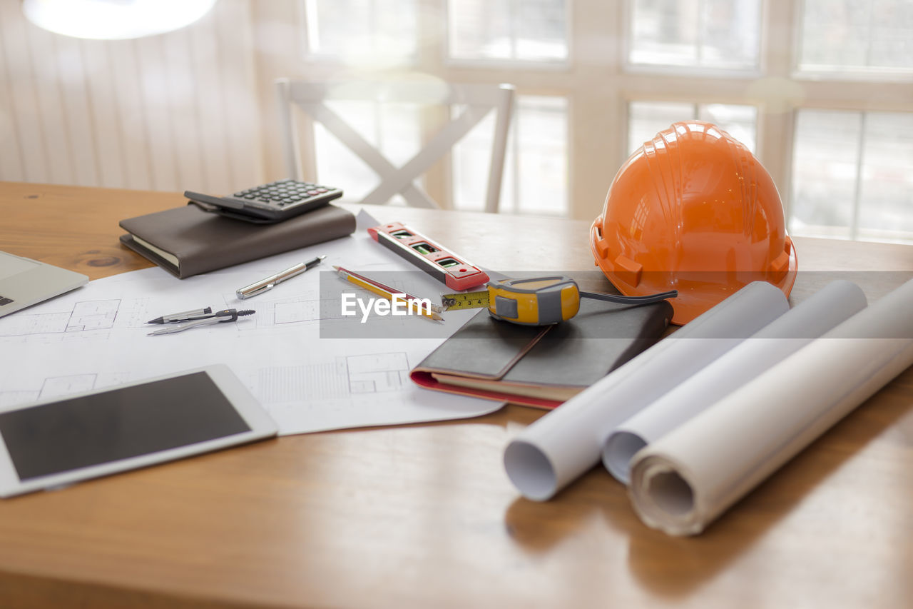 High angle view of digital tablet and office supplies on desk