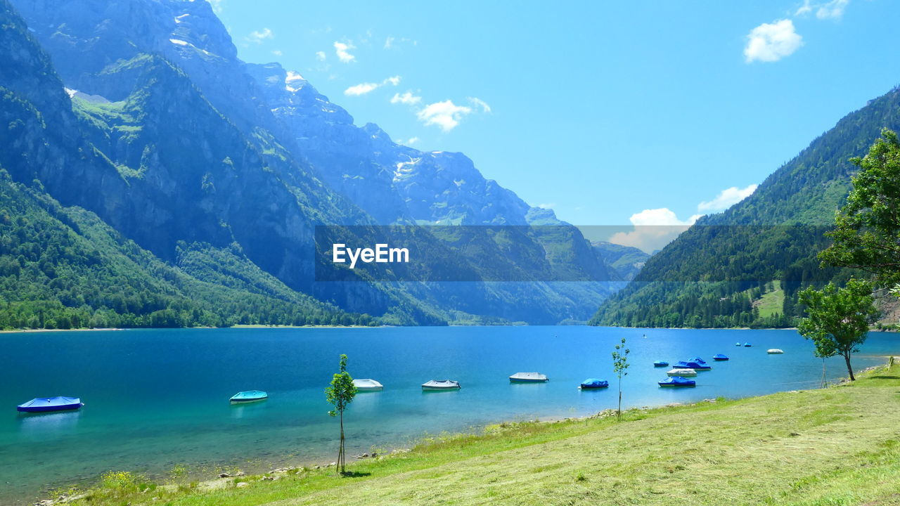 BOATS ON LAKE AGAINST SKY