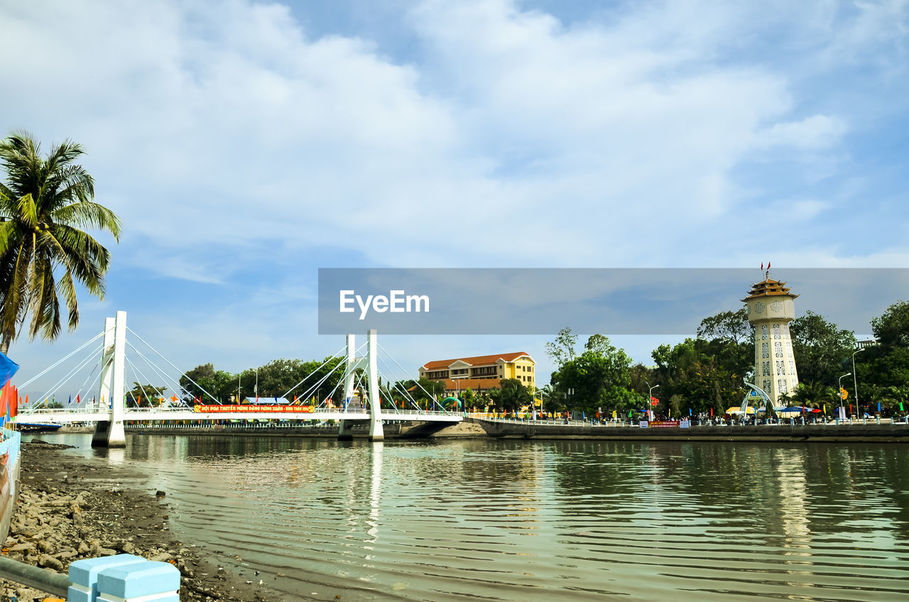 View of bridge over river against cloudy sky