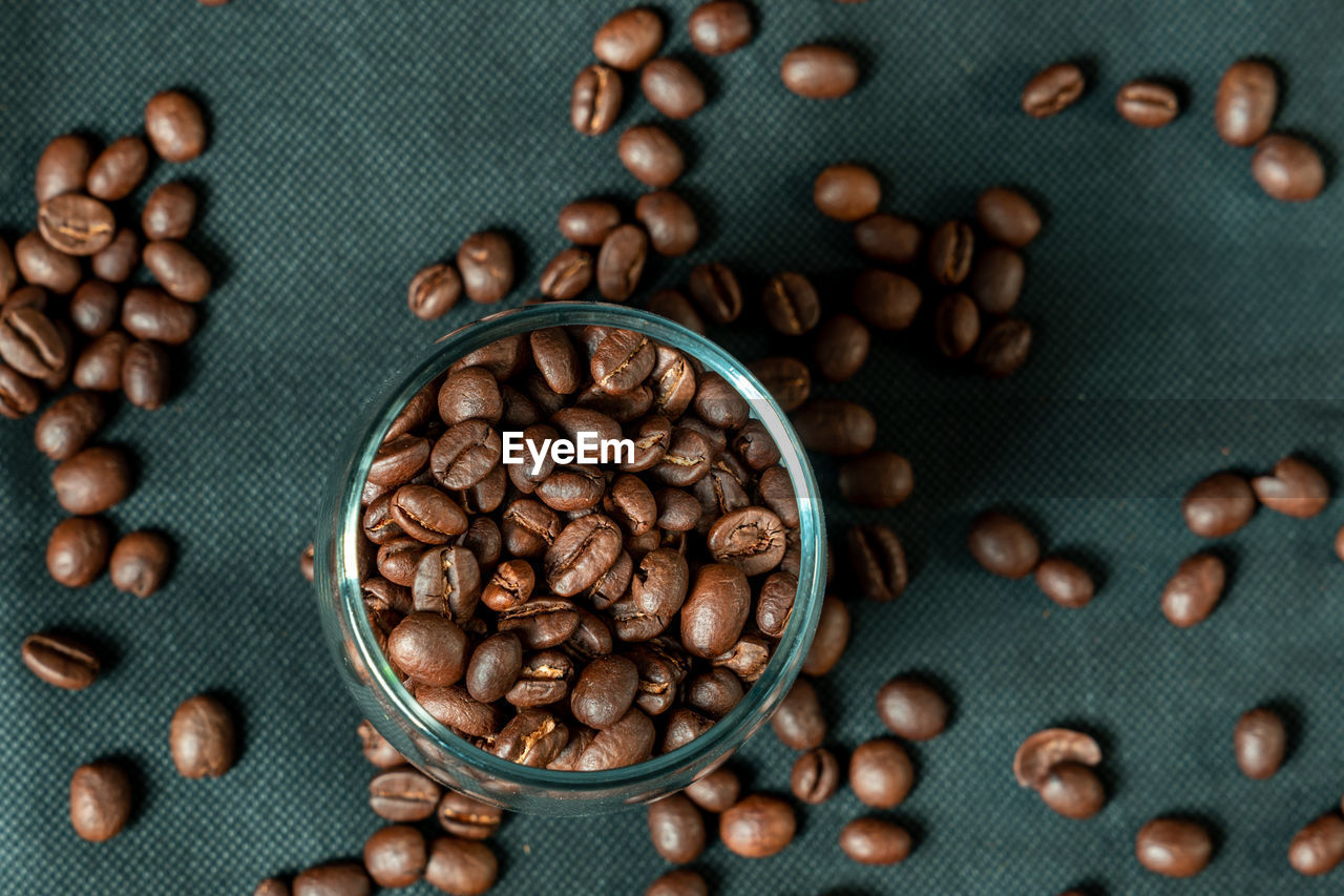 food and drink, roasted coffee bean, food, coffee, freshness, brown, large group of objects, indoors, still life, no people, directly above, studio shot, close-up, cup, drink, high angle view, abundance, produce, raw coffee bean, healthy eating, roasted, seed, dark, table, refreshment