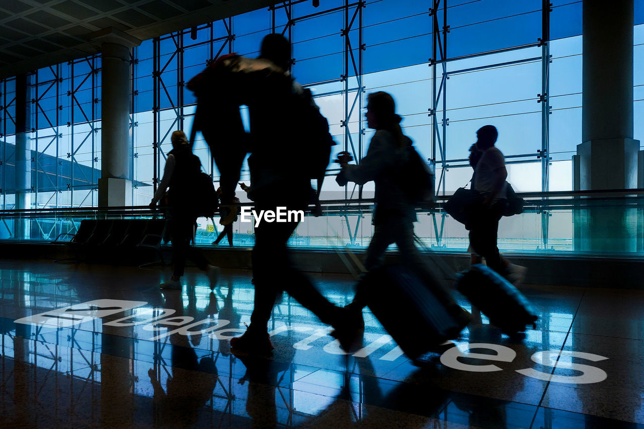 People walking to gate departure of flight. tourists with luggage. travel, tourism, journey concept