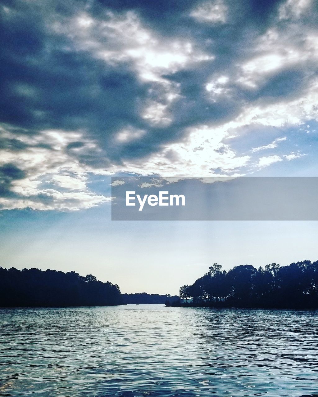 SILHOUETTE TREES BY LAKE AGAINST SKY