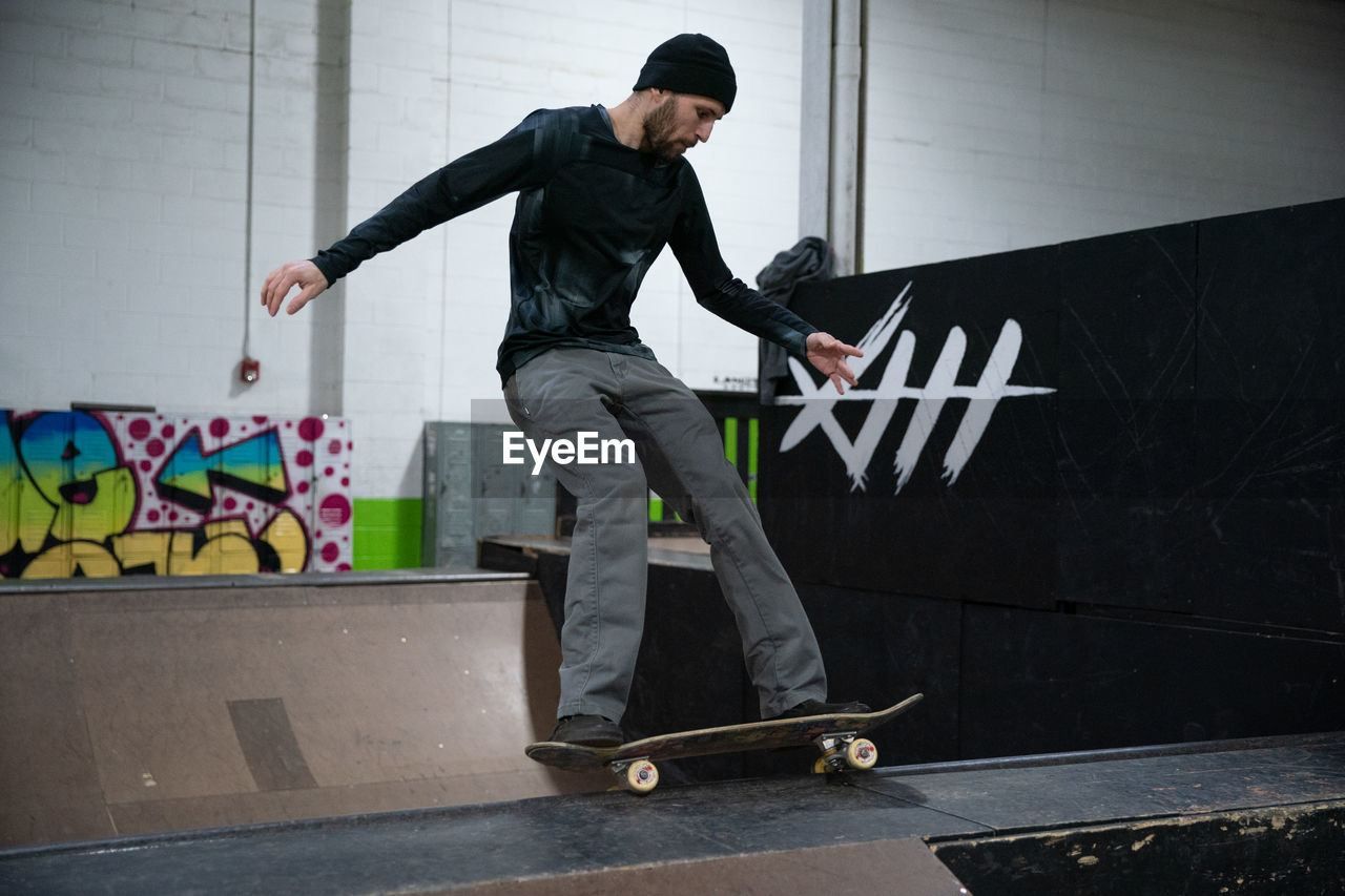 MAN SKATEBOARDING ON SKATEBOARD