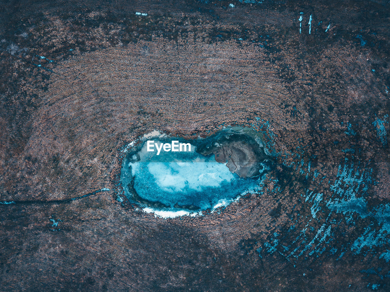 HIGH ANGLE VIEW OF ICE CRYSTALS ON ROCK