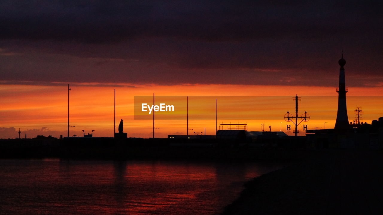 sky, sunset, afterglow, water, silhouette, cloud, dawn, industry, orange color, horizon, nature, architecture, evening, built structure, beauty in nature, technology, power generation, reflection, no people, factory, transportation, sea, dramatic sky, outdoors, scenics - nature, electricity, business finance and industry, environment, tower, nautical vessel, tranquility, skyline