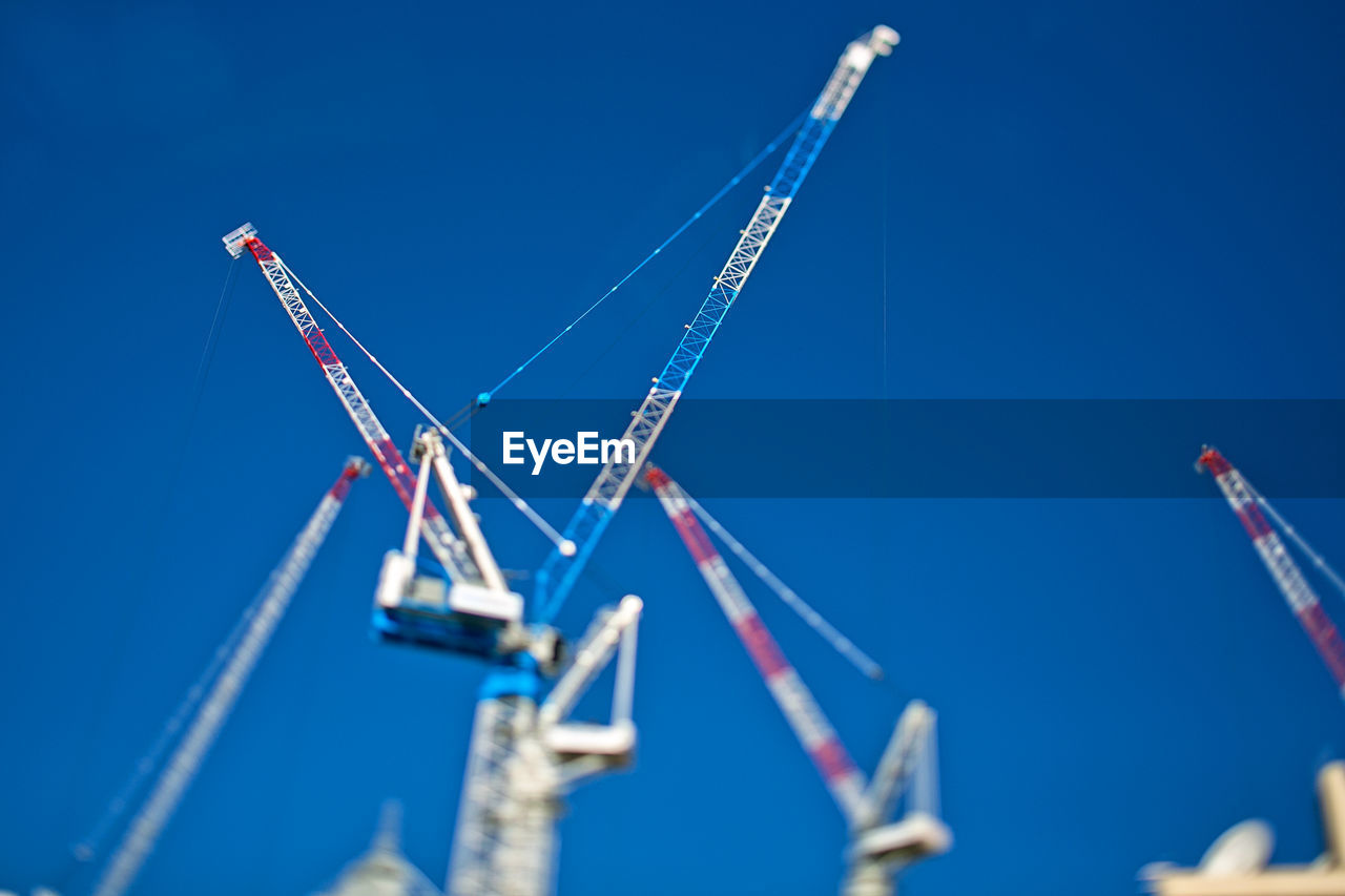 Low angle view of cranes