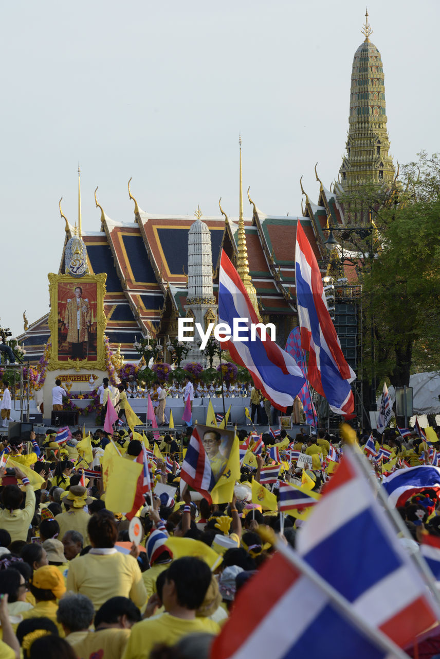 High angle view of people with thai flags at event outside temple