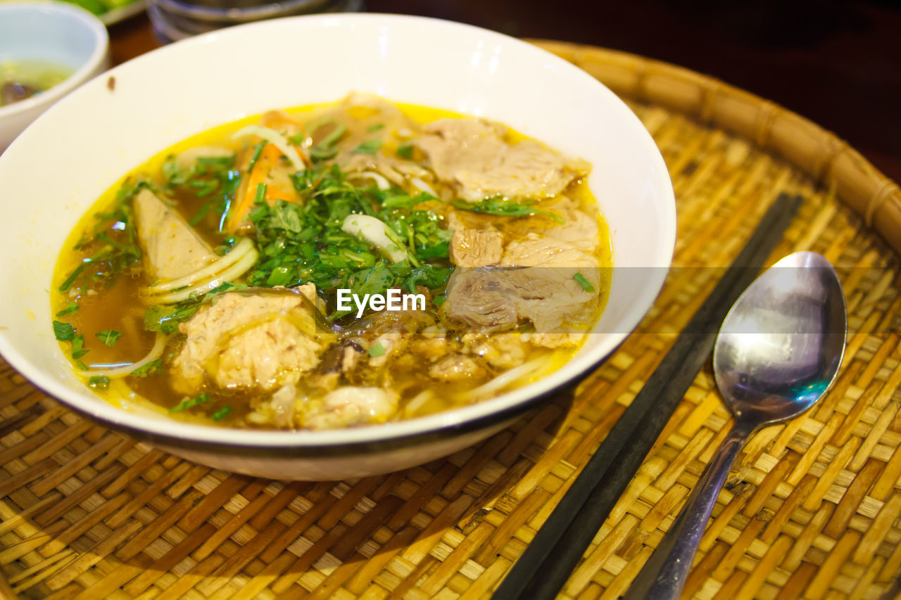 High angle view of fresh pho served in wicker tray