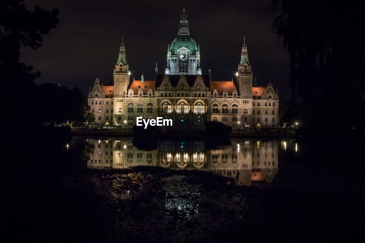 Reflection of building in water at night