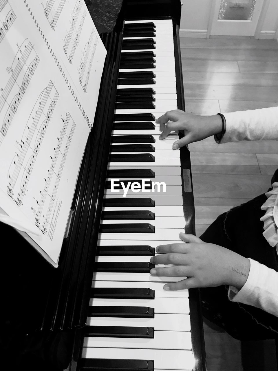 Midsection of woman playing piano