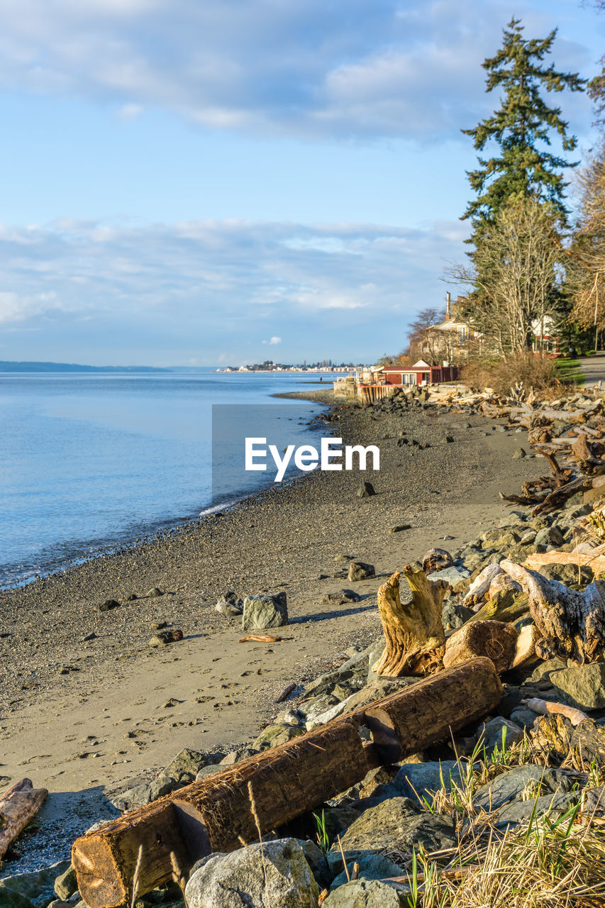A view of the beach and waterfront homes at lincoln park in west seattle, washington.