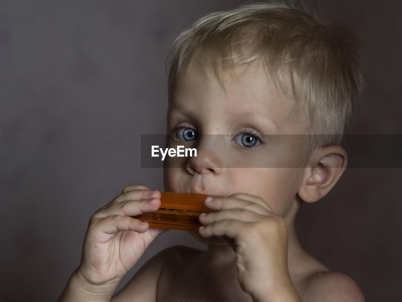 CLOSE-UP OF GIRL HOLDING TOY