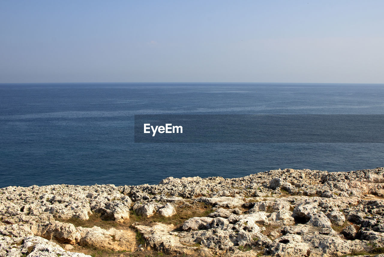 Scenic view of rock and sea against sky in havana.