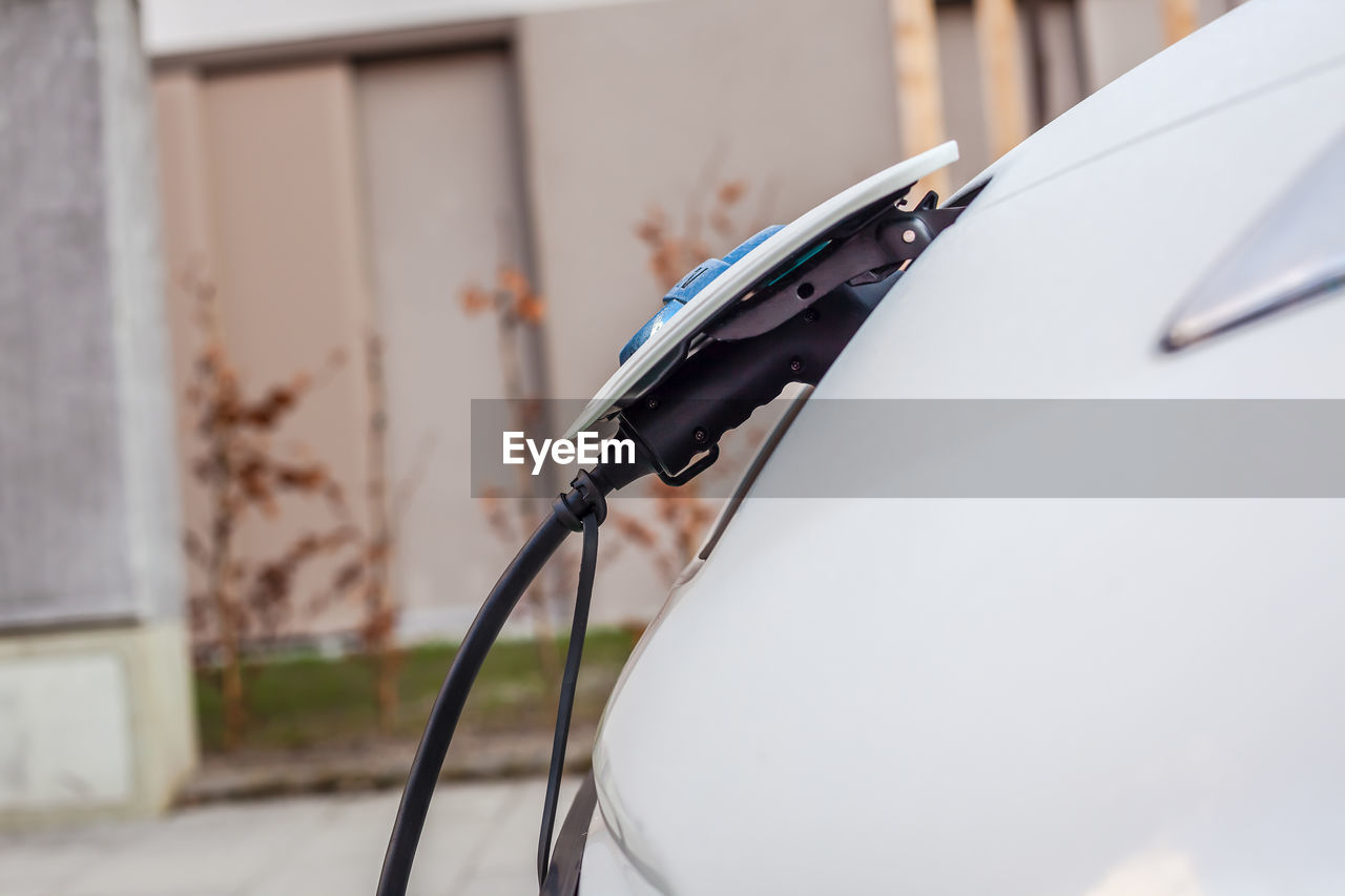 CLOSE-UP OF WHITE CAR ON METAL