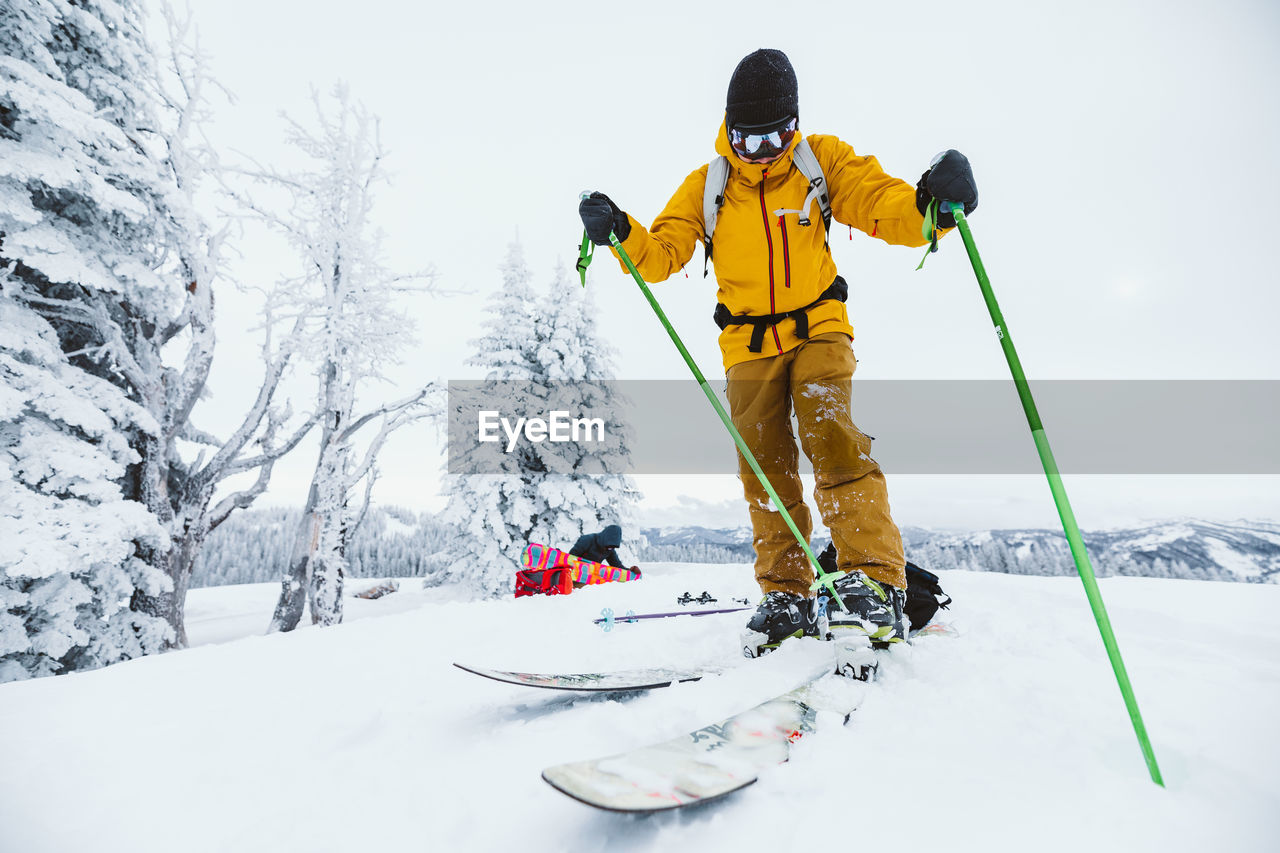 Skier clips in to binding after hiking to ski wyoming backcountry