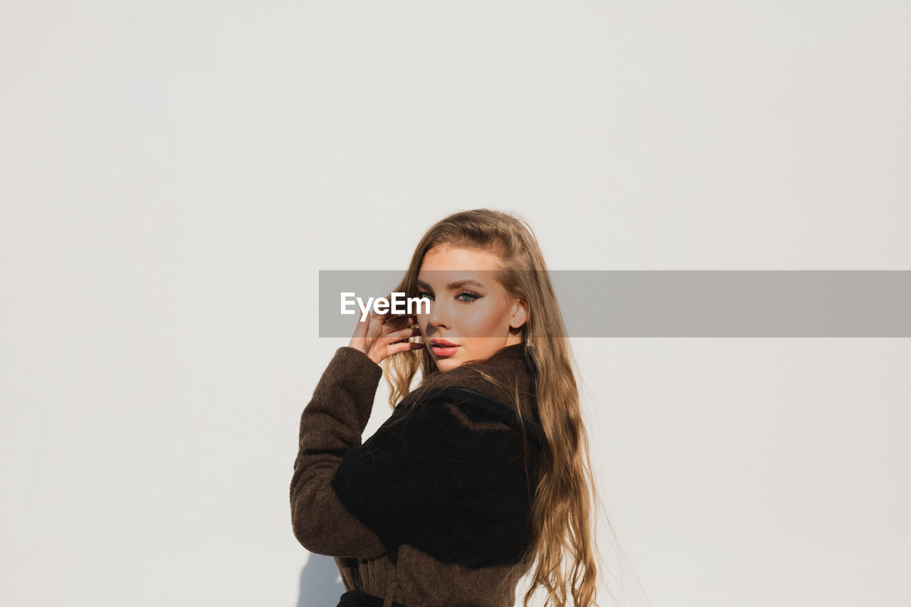 Portrait of a beautiful young woman over white background