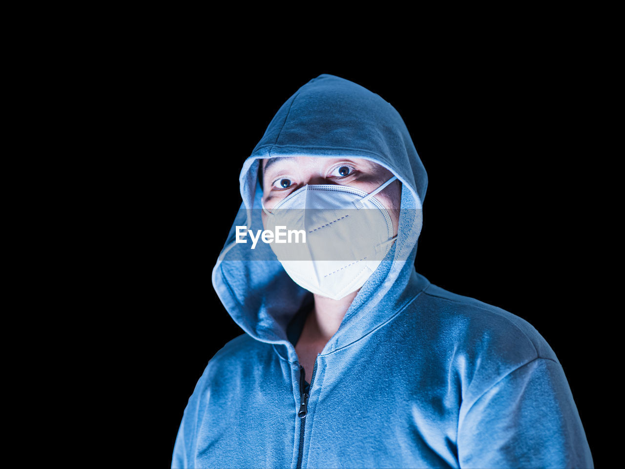 black background, blue, portrait, studio shot, one person, adult, surgical mask, indoors, protective mask - workwear, healthcare and medicine, headshot, surgeon, looking at camera, front view, copy space, human face, cut out, protection, clothing, security, men, young adult, person, obscured face