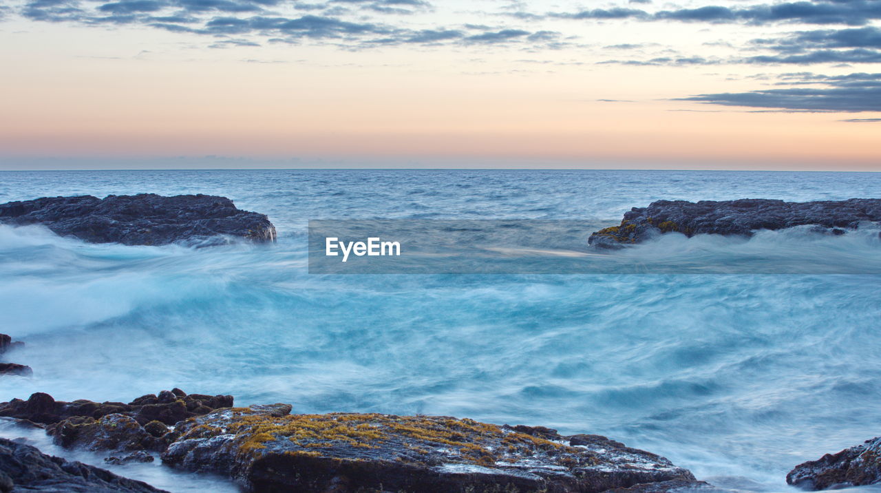 Scenic view of sea against sky during sunset