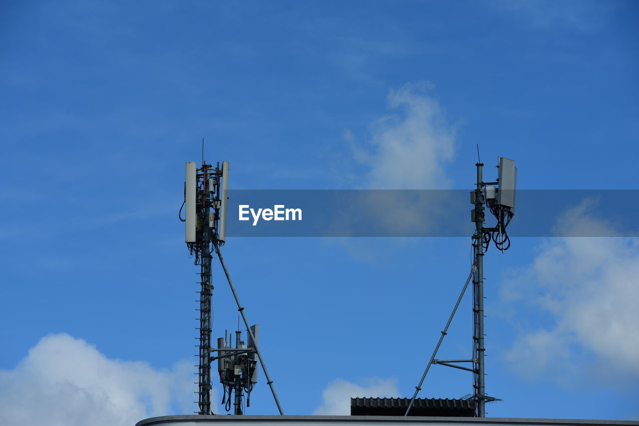 LOW ANGLE VIEW OF CRANES AGAINST SKY