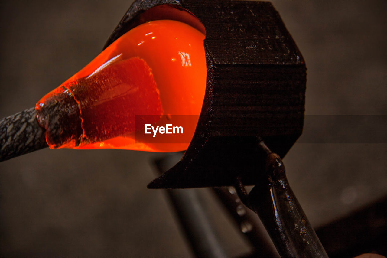 Close-up of glass being molded in factory