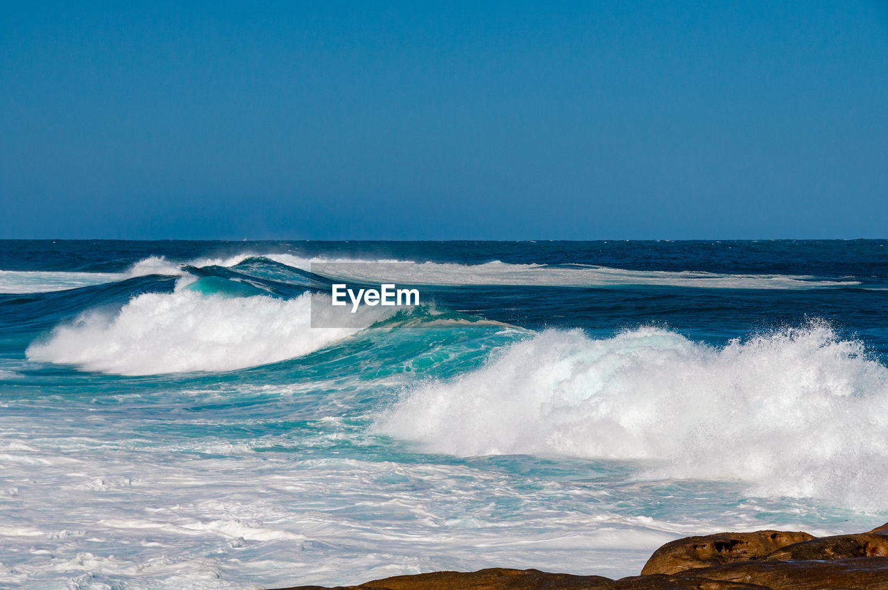 Big ocean wave with clear blue sky. nature background