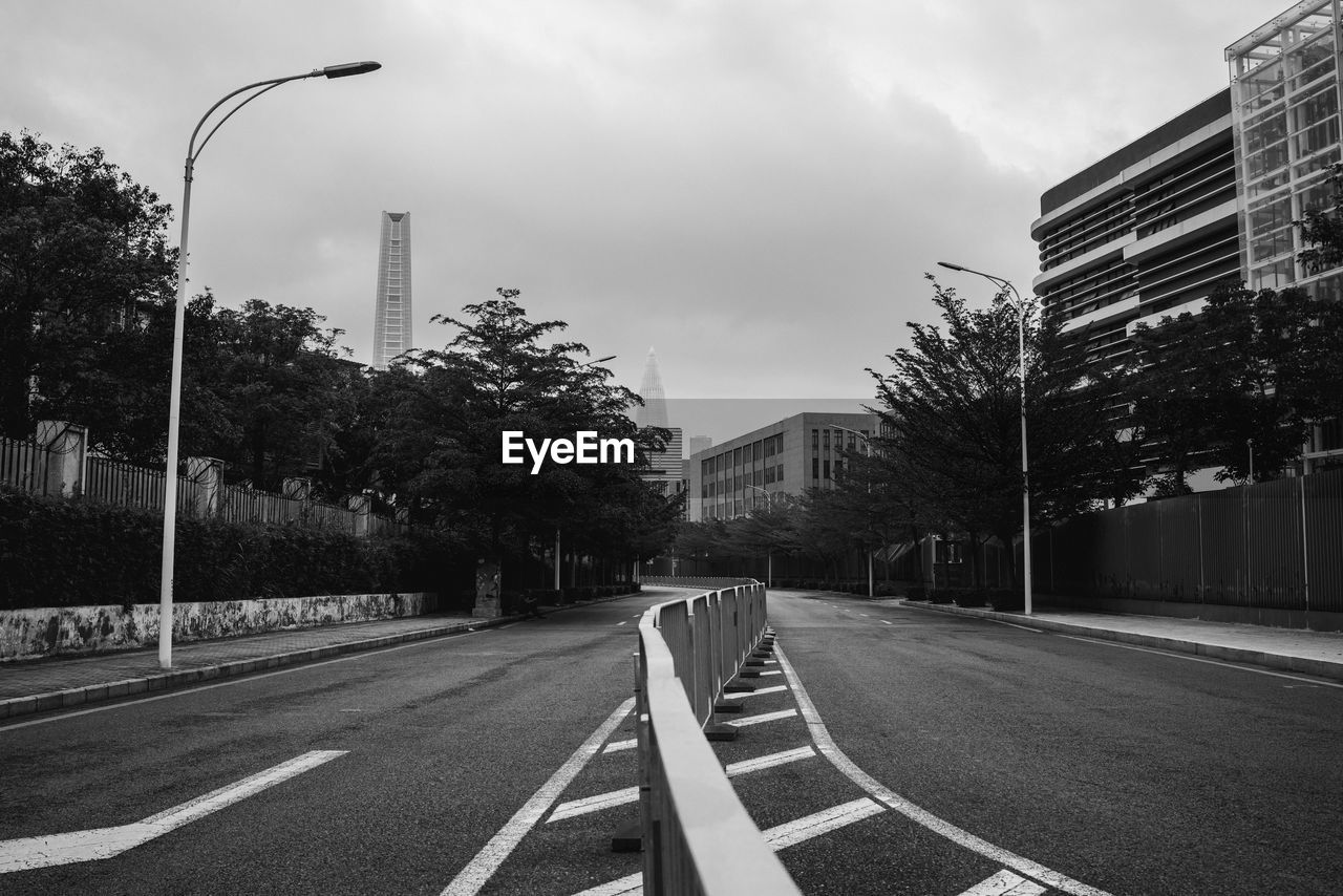 Road by city against sky