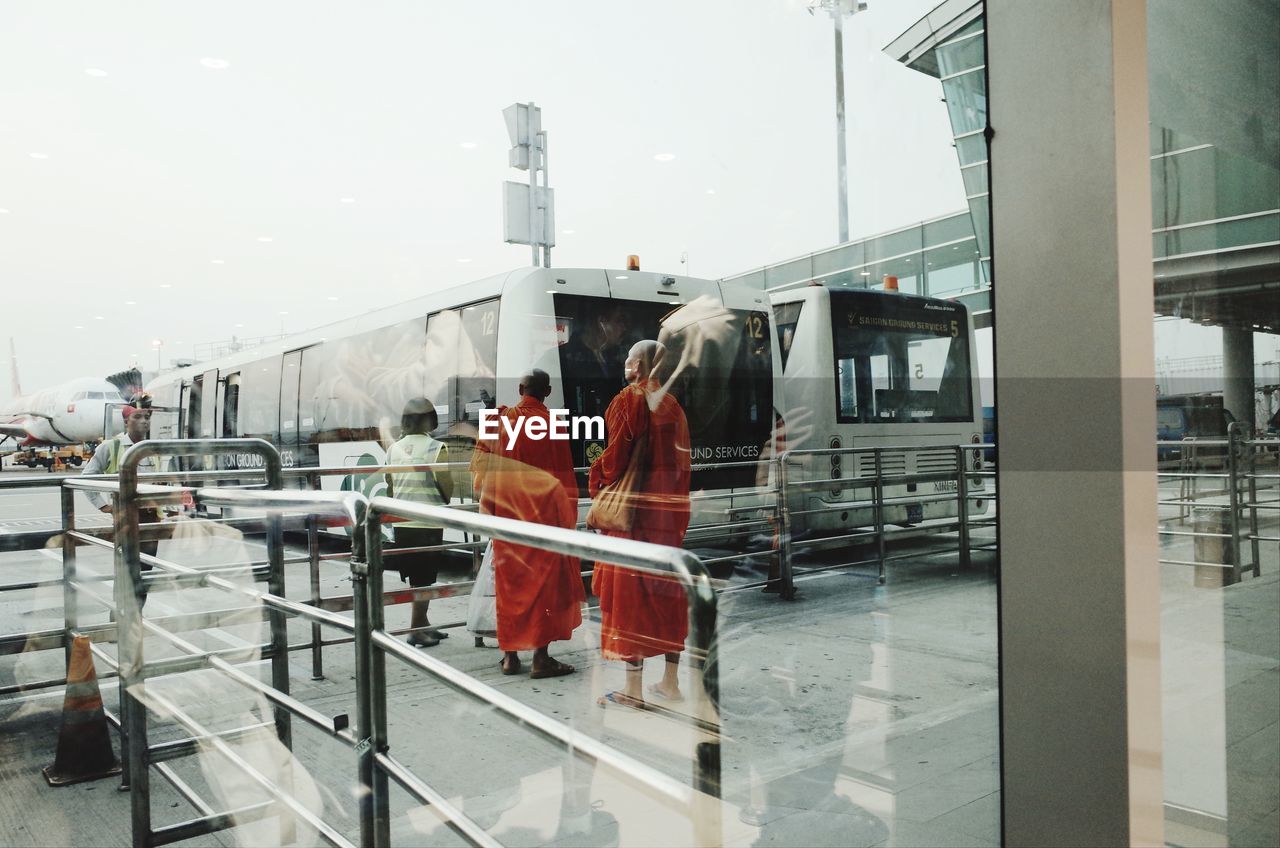 PEOPLE WALKING ON RAILROAD STATION PLATFORM