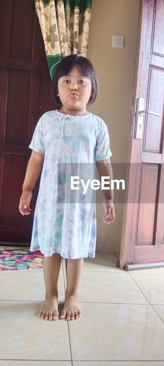 childhood, child, full length, one person, standing, portrait, innocence, front view, barefoot, looking at camera, cute, dress, smiling, toddler, female, emotion, indoors, clothing, happiness, men, door, women, entrance, day, lifestyles, person, baby & toddler clothing, casual clothing, spring, looking