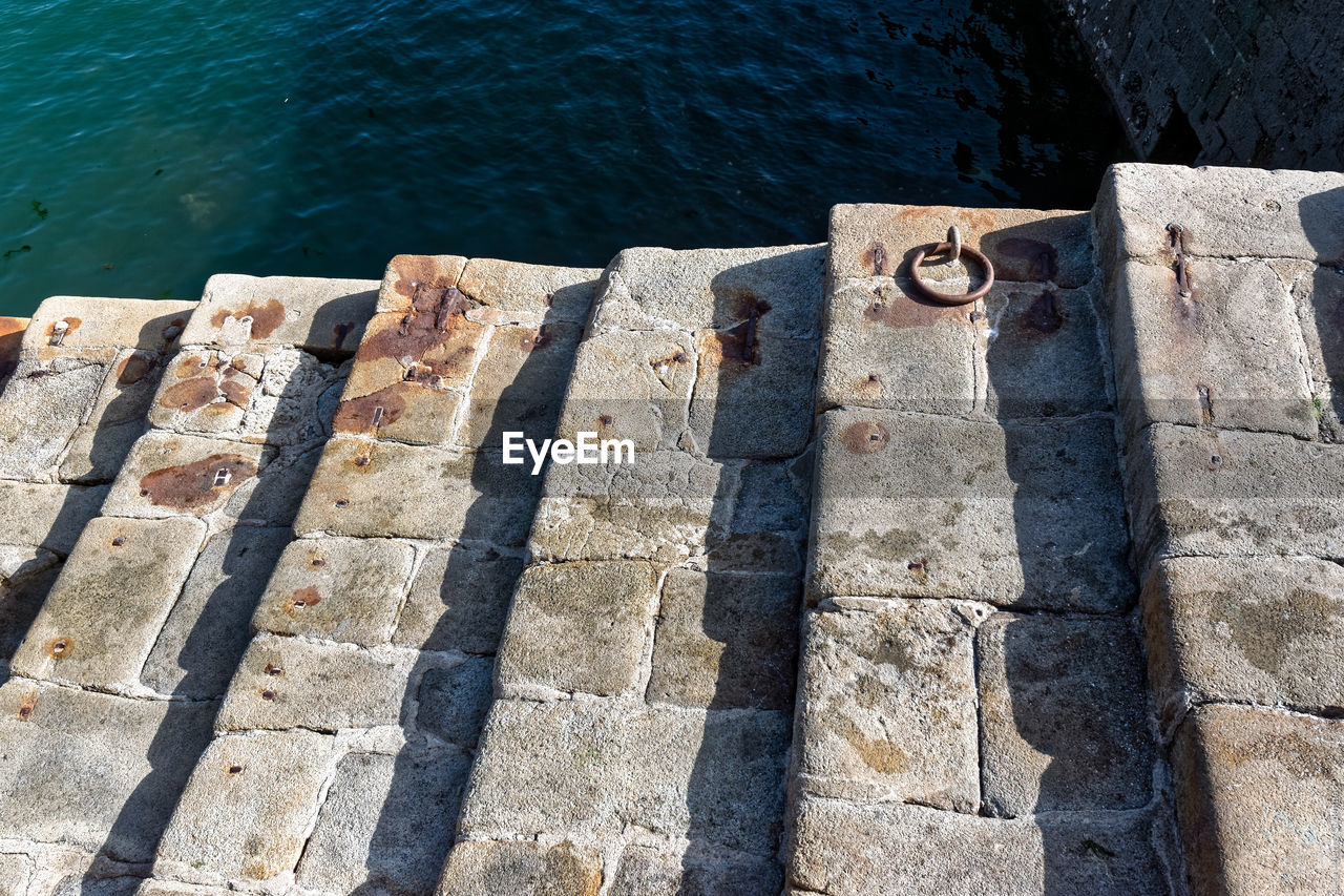 Close-up of staircase by lake