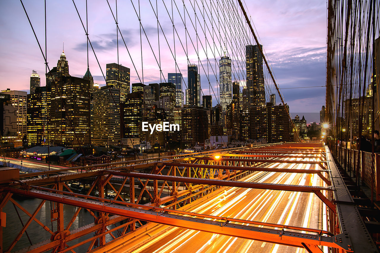 Illuminated cityscape against sky at night