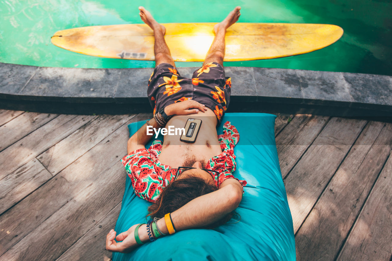 Man relaxing at poolside 