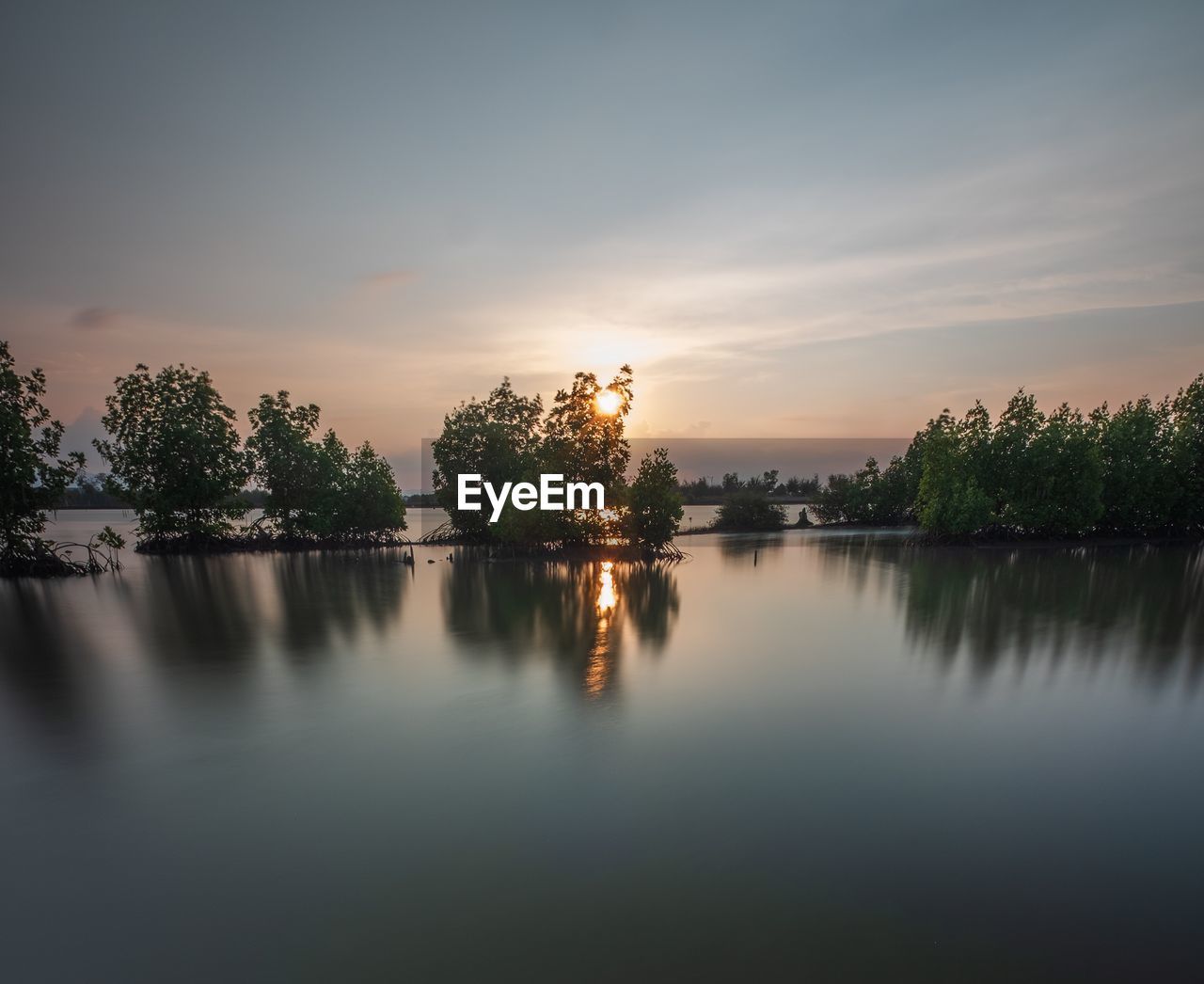 Scenic view of lake against sky during sunset