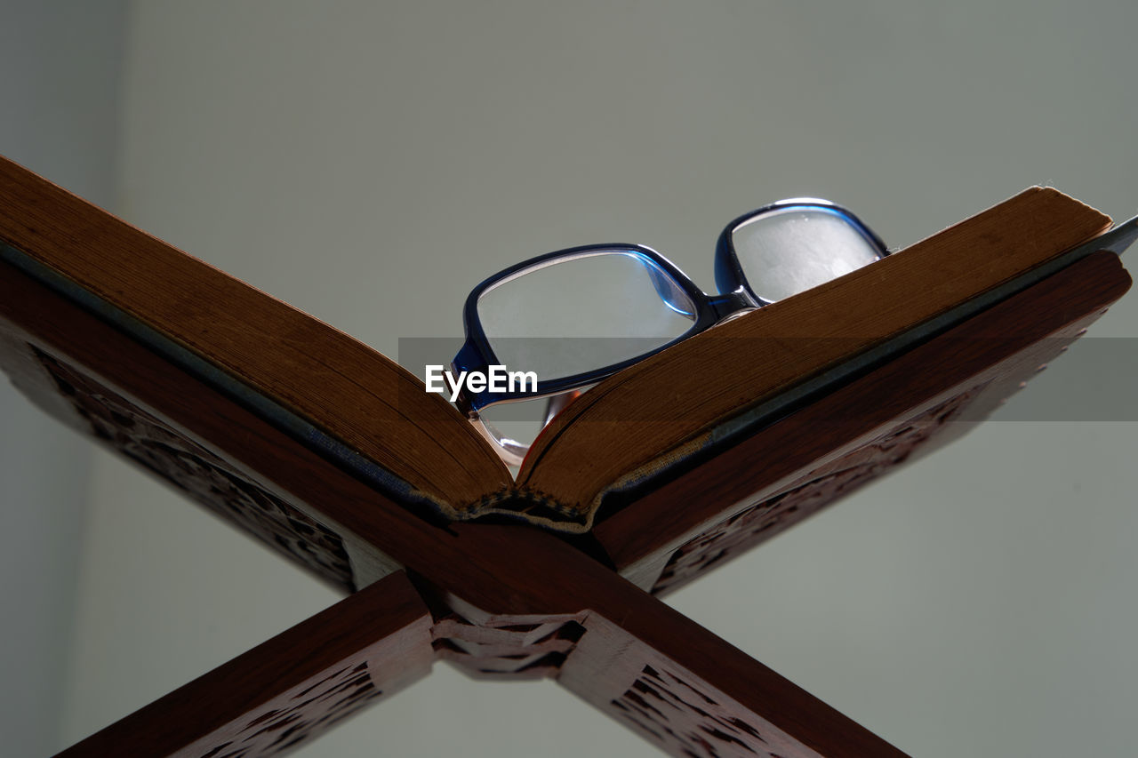 Koran and reading glass on wood stand