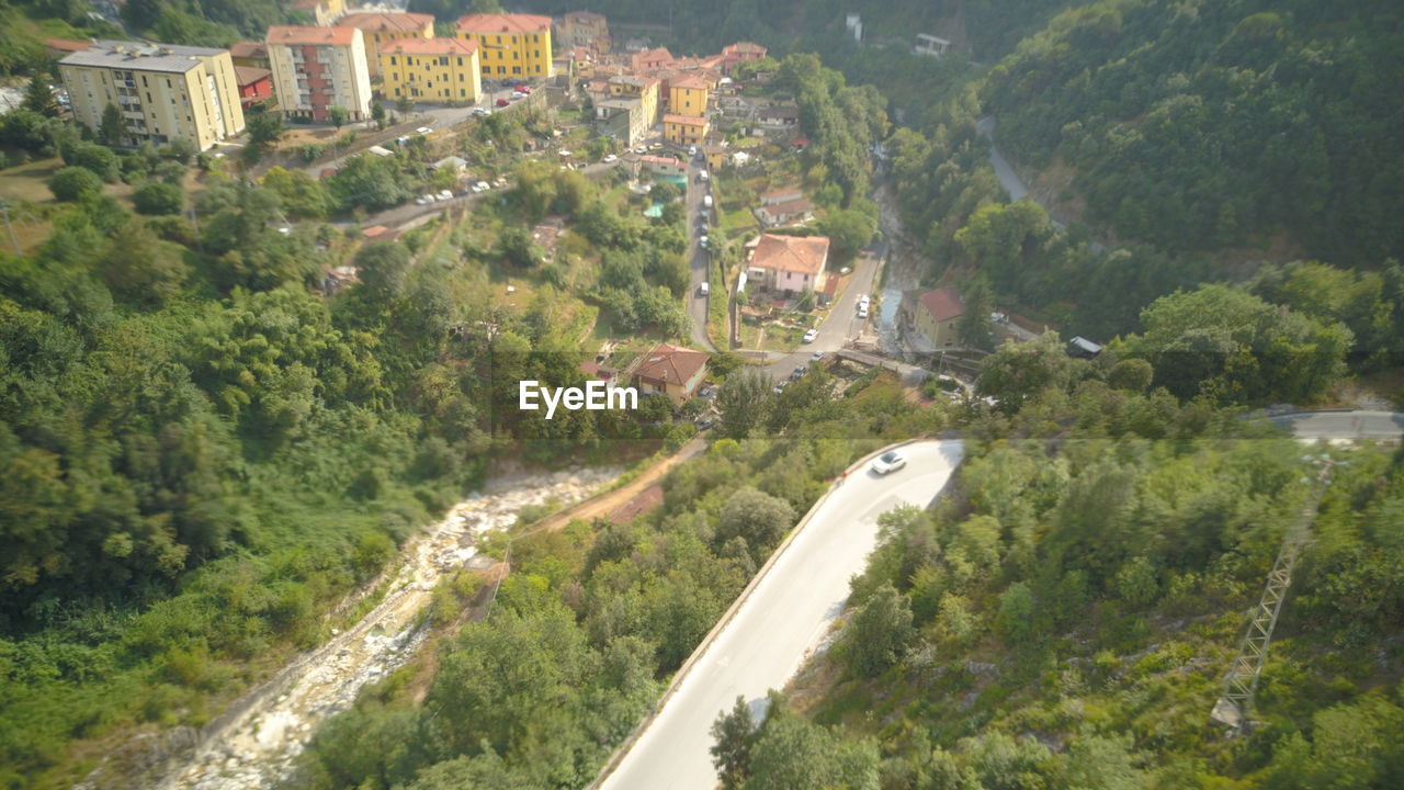 HIGH ANGLE VIEW OF STREET AMIDST TREES AND CITY