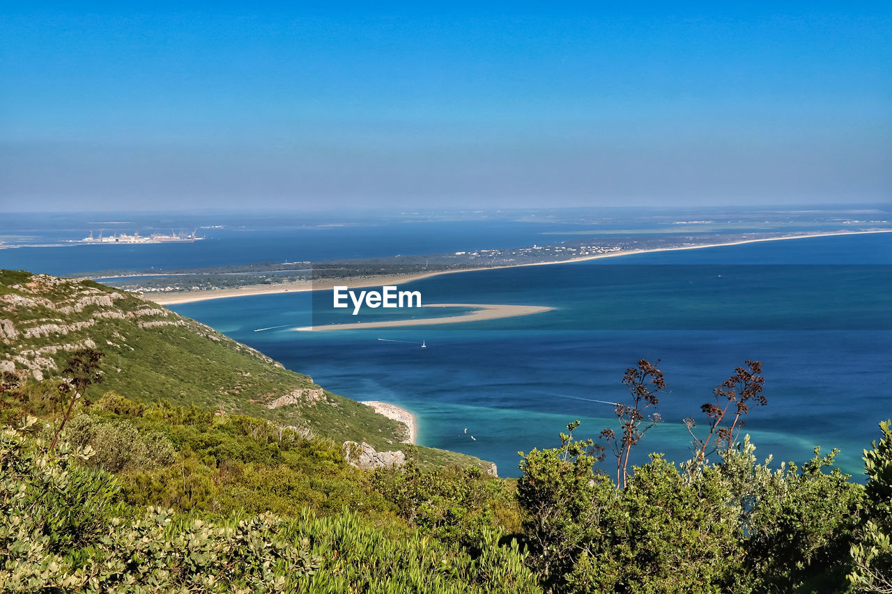 SCENIC VIEW OF BEACH AGAINST BLUE SKY