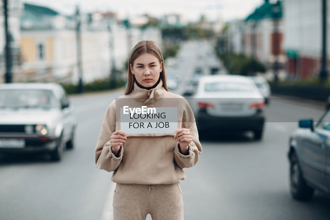 MAN STANDING ON STREET AGAINST CITY