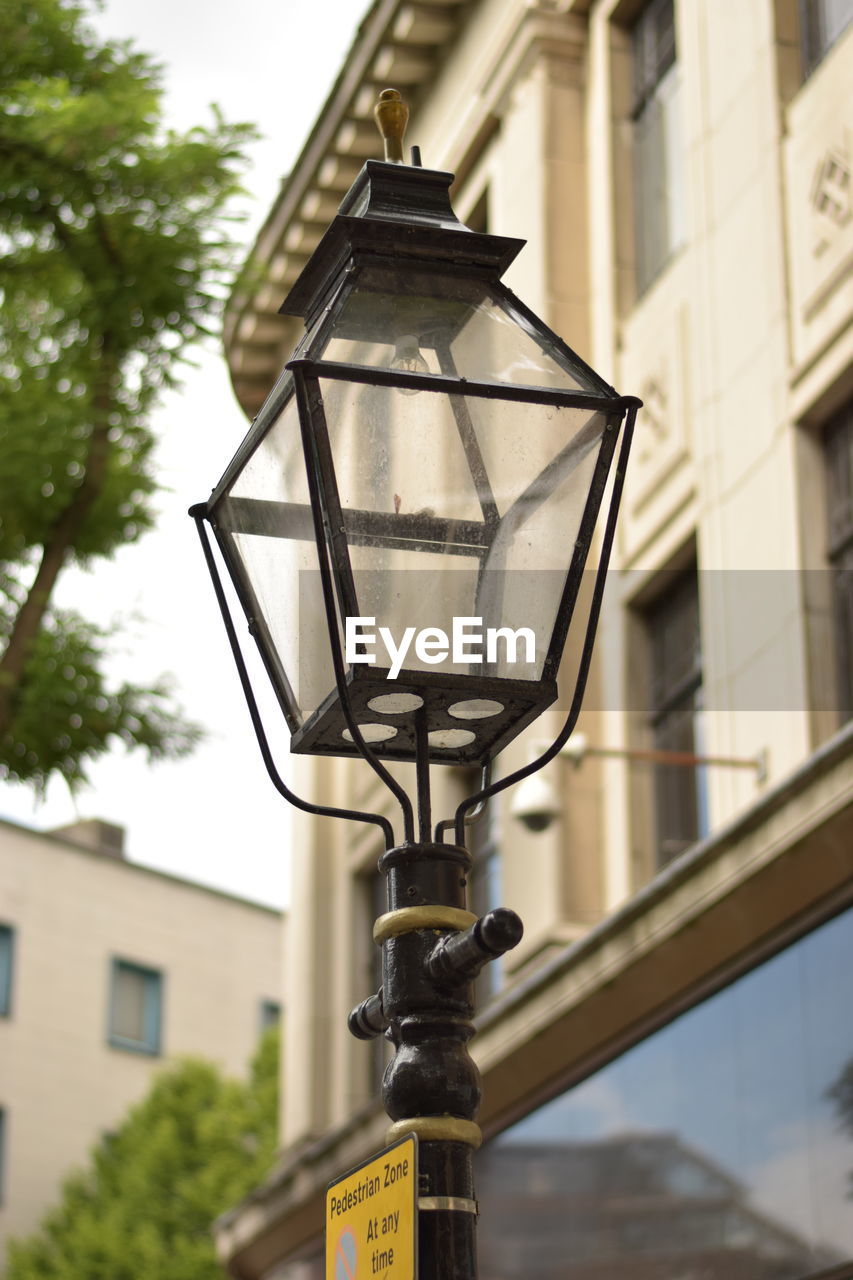 Low angle view of street light against building