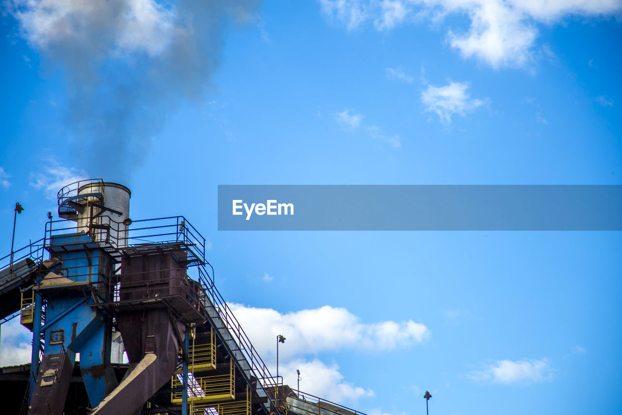 LOW ANGLE VIEW OF SMOKE STACK AGAINST SKY