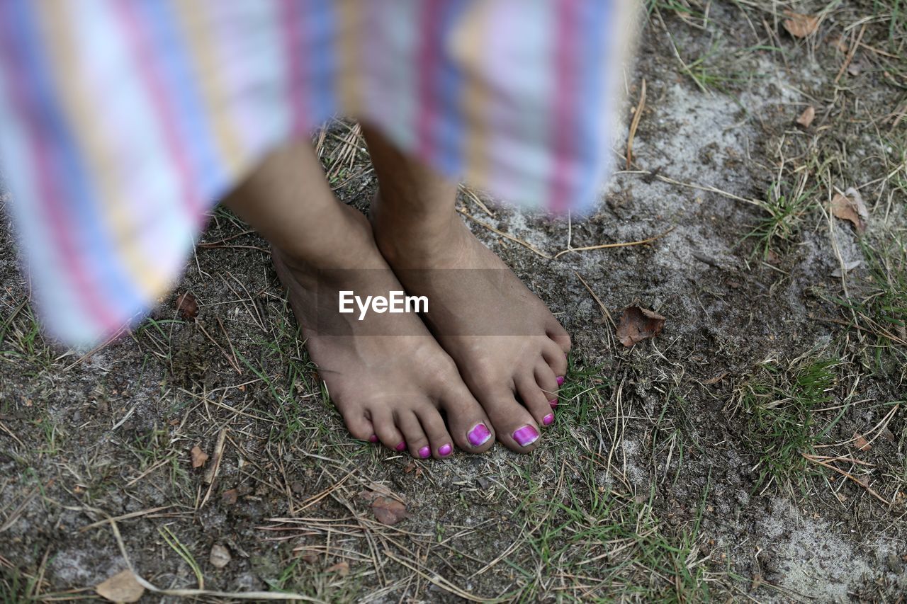 Low section of woman standing on land