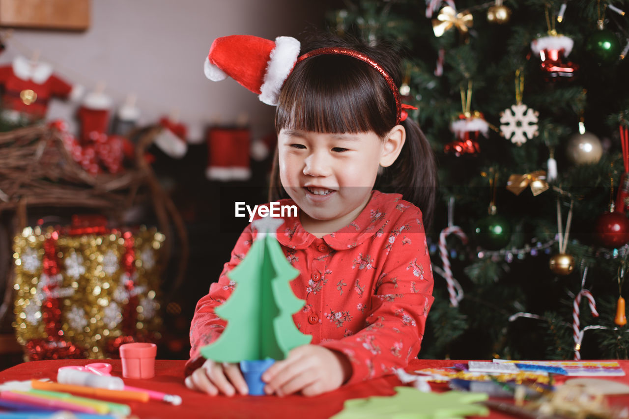 Young girl making christmas craft at home