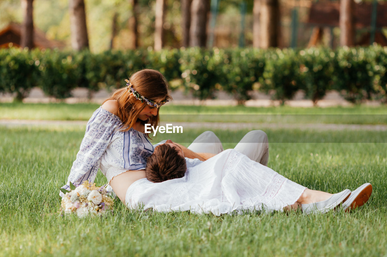 Couple sitting on grass outdoors