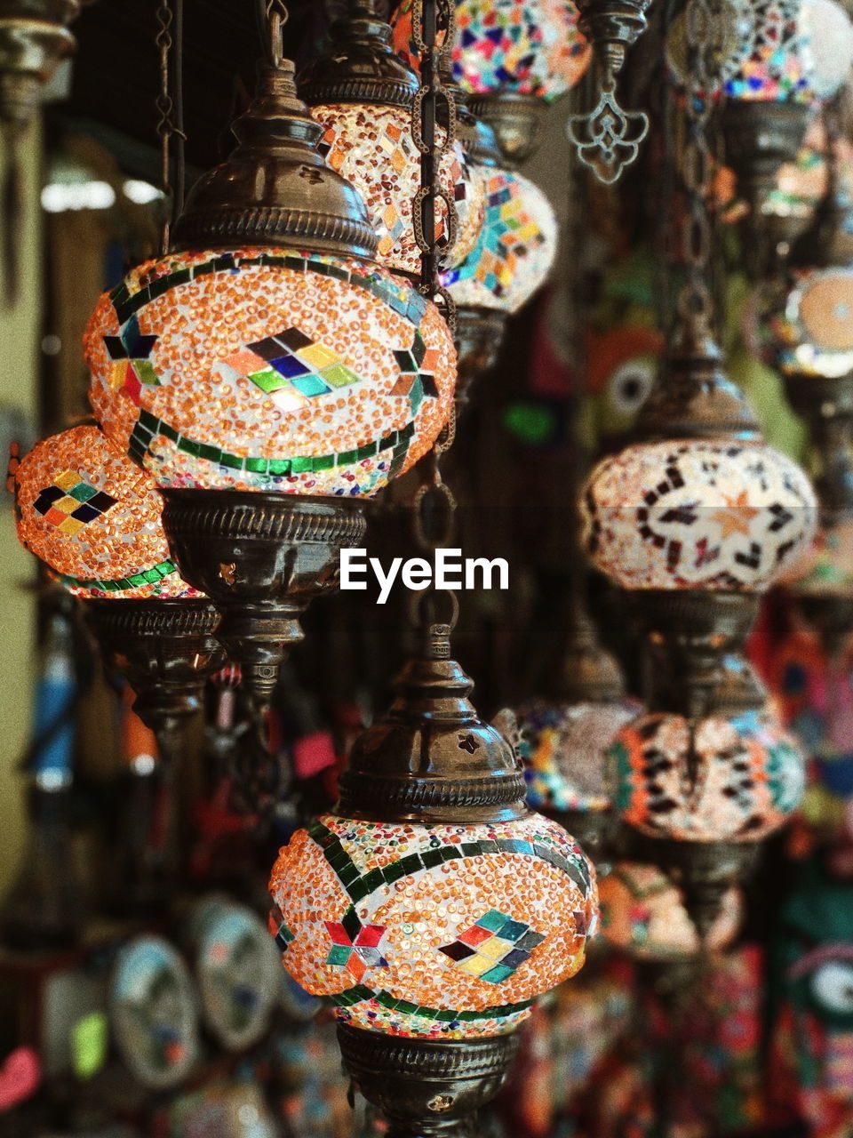 Close-up of decorations hanging for sale in market