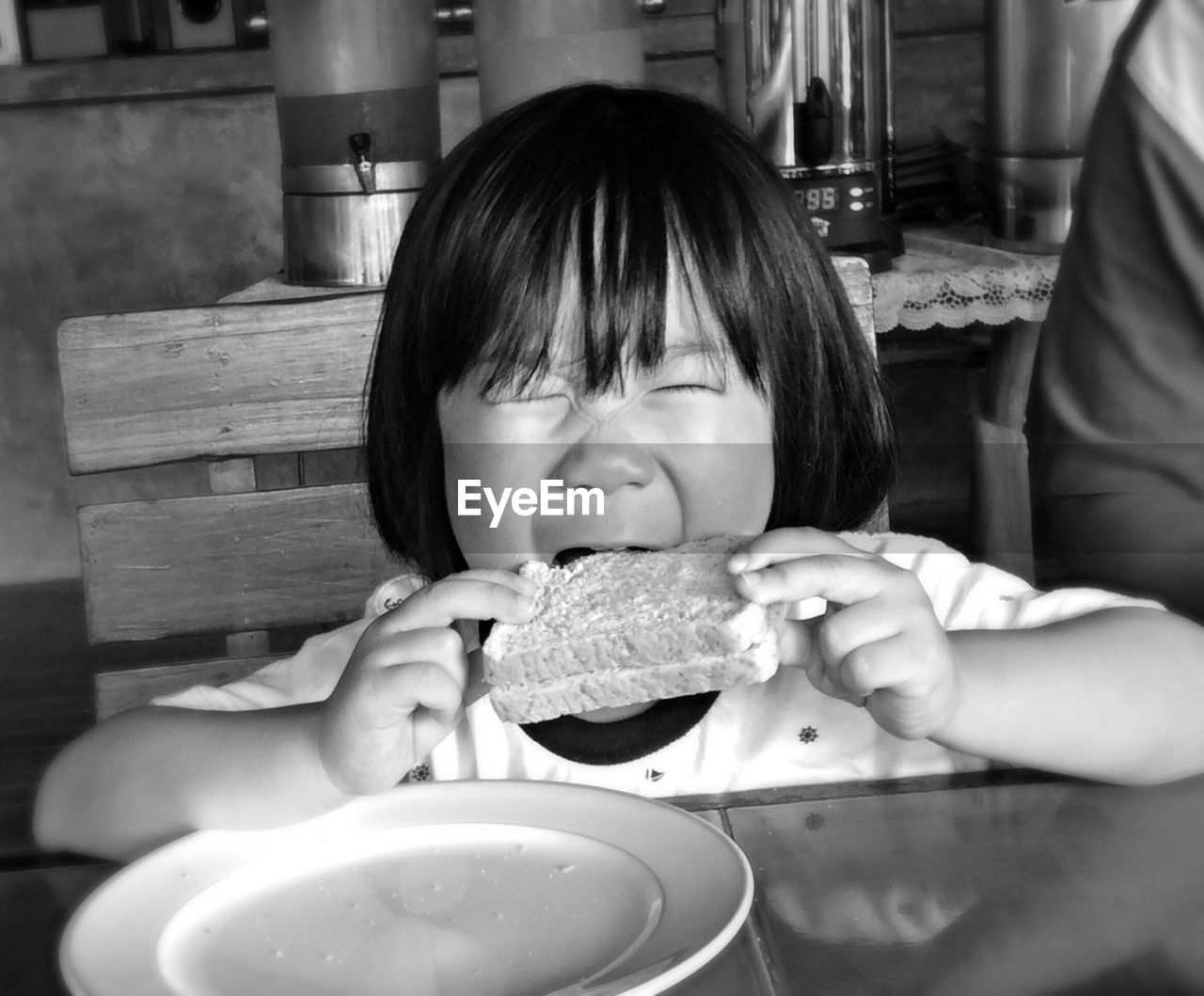 Portrait of cute child eating sandwich