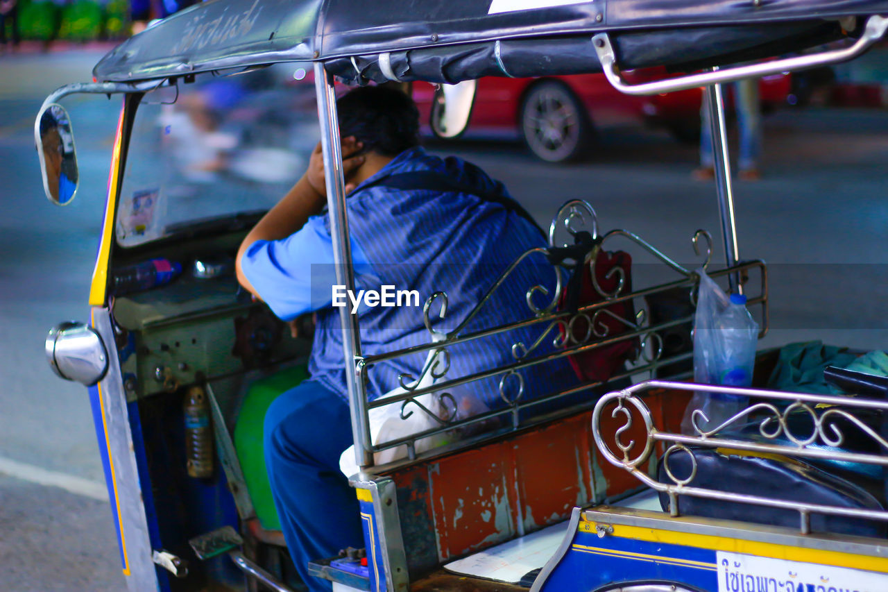 Rear view of man sitting in taxi